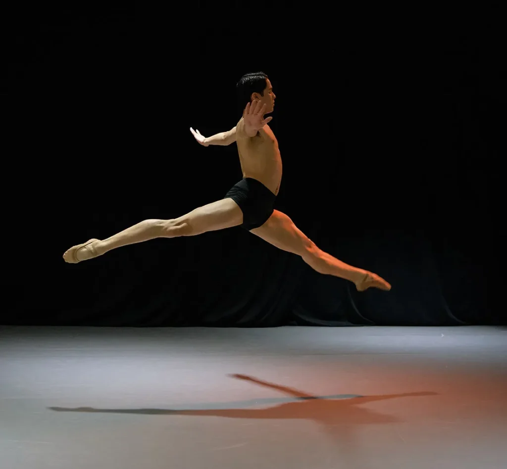 Male dancer leaping during a contemporary ballet performance