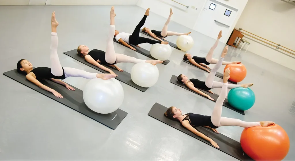 Body Conditioning class performing core strengthening exercises on stability balls in our beautiful studios