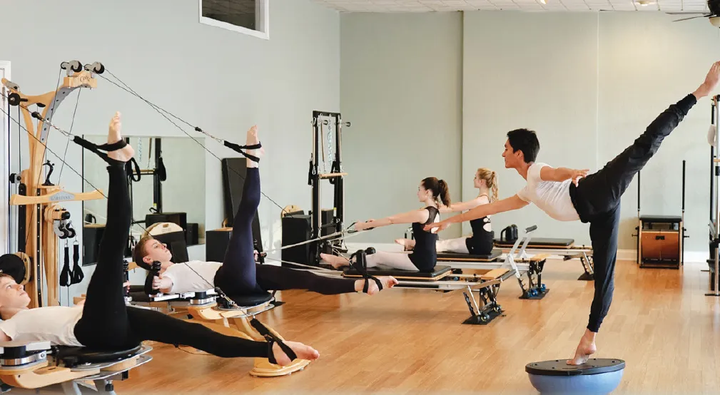 Students performing body conditioning, Pilates, and GYROTONIC® exercises in our beautiful studios