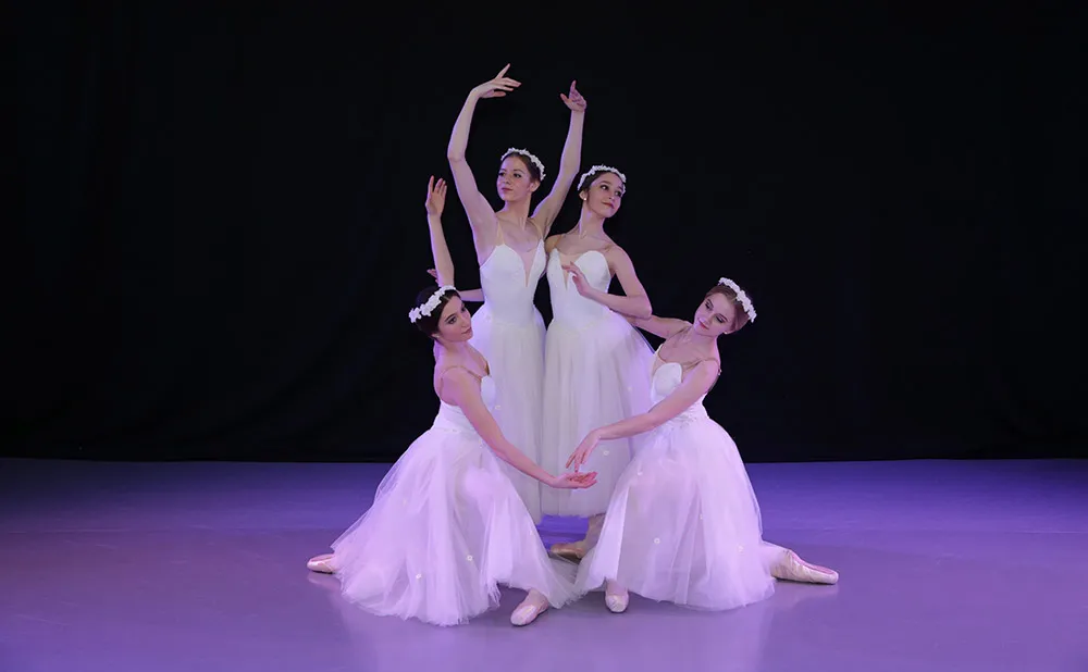 Four dancers performing a scene from the ballet La Sylphide